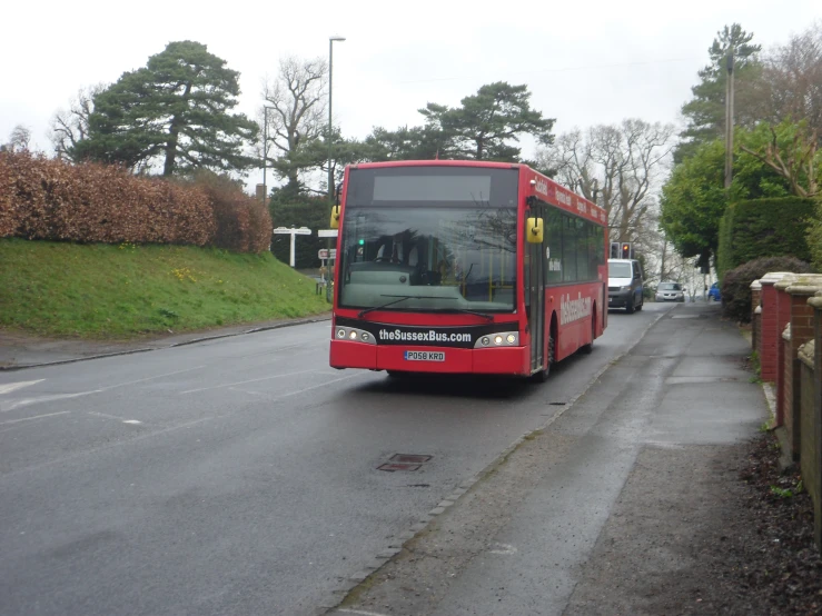 a red bus is going down the street