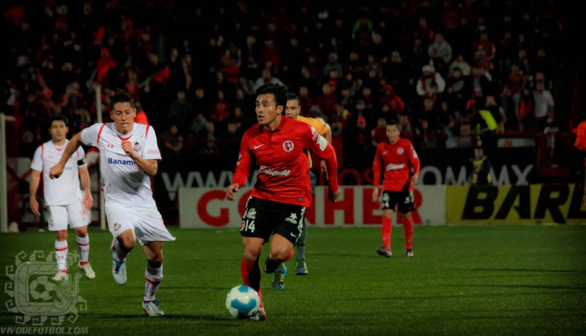 soccer players in red and white playing a game