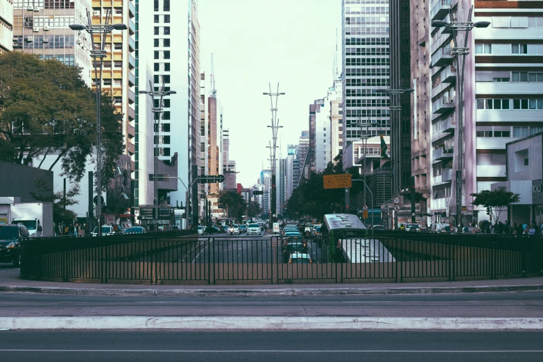 people are sitting and walking along the street in the city