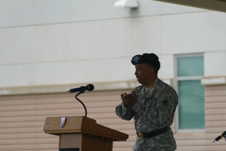 a soldier is speaking into a microphone at an event