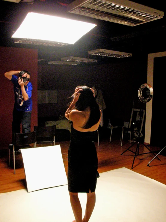 a woman is taking a po of a camera in a studio