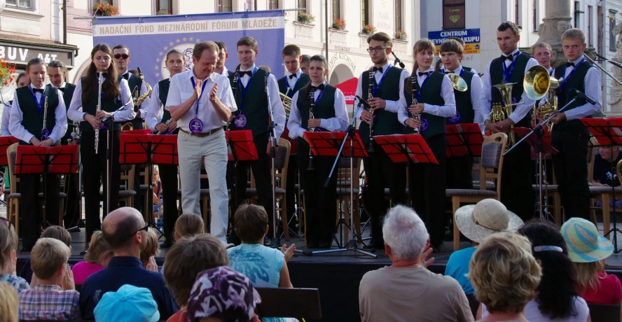 the young men are performing at the public event