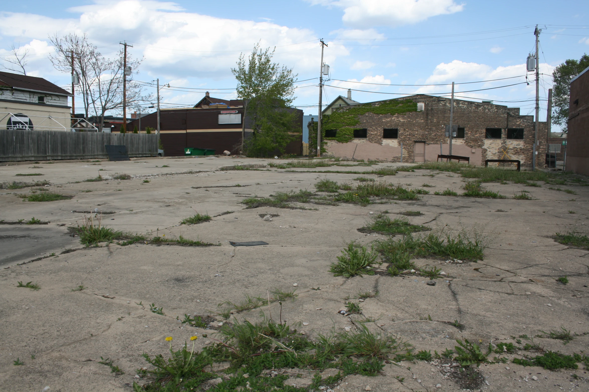 a lot of dirt with buildings and trees in the background