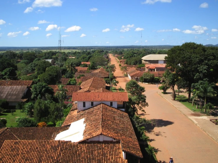 a bird - eye view shows a red roof and two rows of white buildings with white tile walls