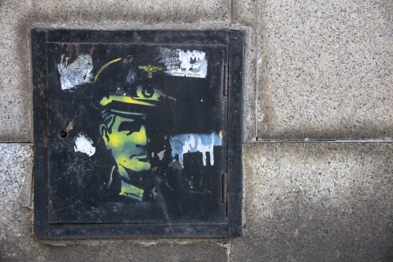 a person in a green hat and a painting on the side of a building