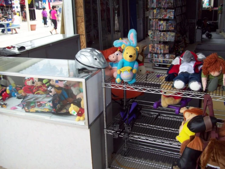 various stuffed animals are lined up in shelves