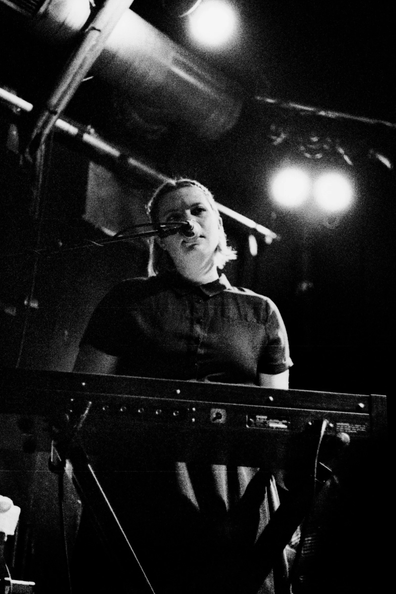 a man in front of a keyboard on stage