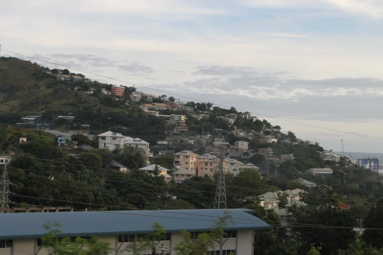 a picture of buildings on a hill with power lines in the background