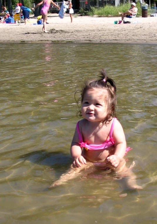 a little girl in the water at the beach