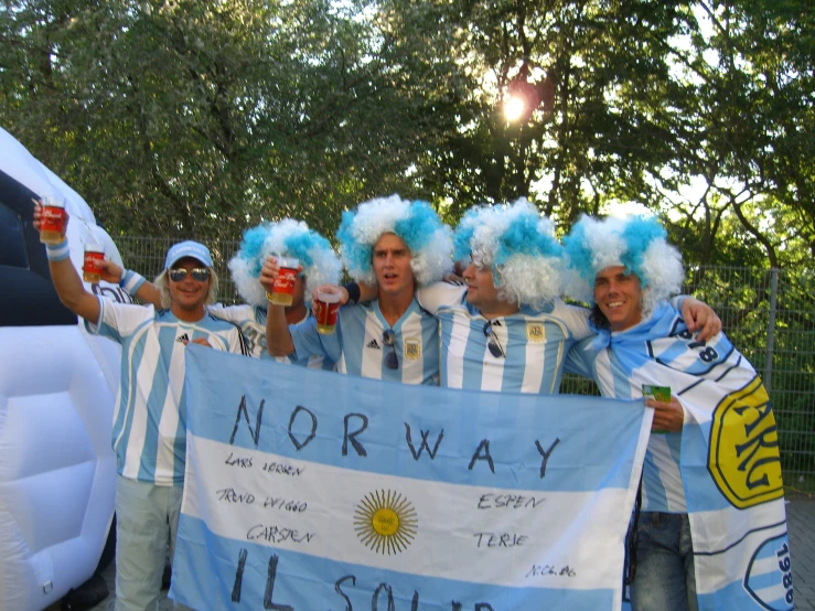 a group of people holding up some very large banners