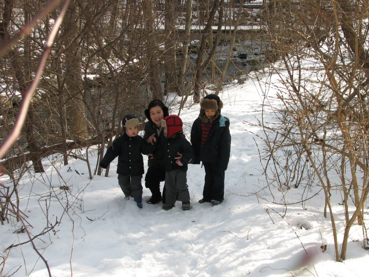 a group of three s pose for a po in the snow