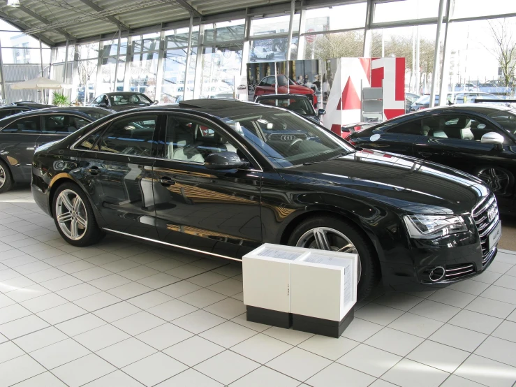 cars are parked in front of a large display case