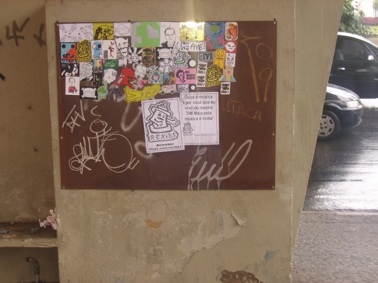 a city corner with graffiti and stickers all over