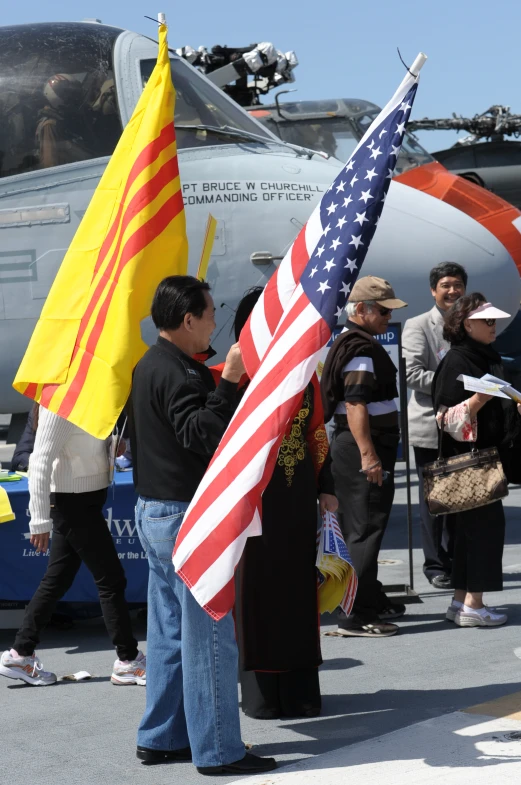 people are standing around in front of an aircraft