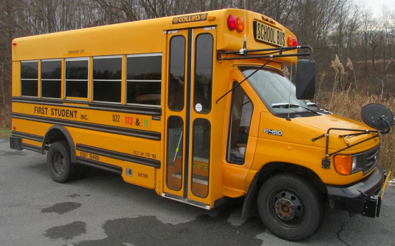 a yellow school bus parked next to a parking meter