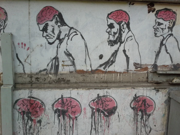 graffiti on the side of a building depicting men with in issues
