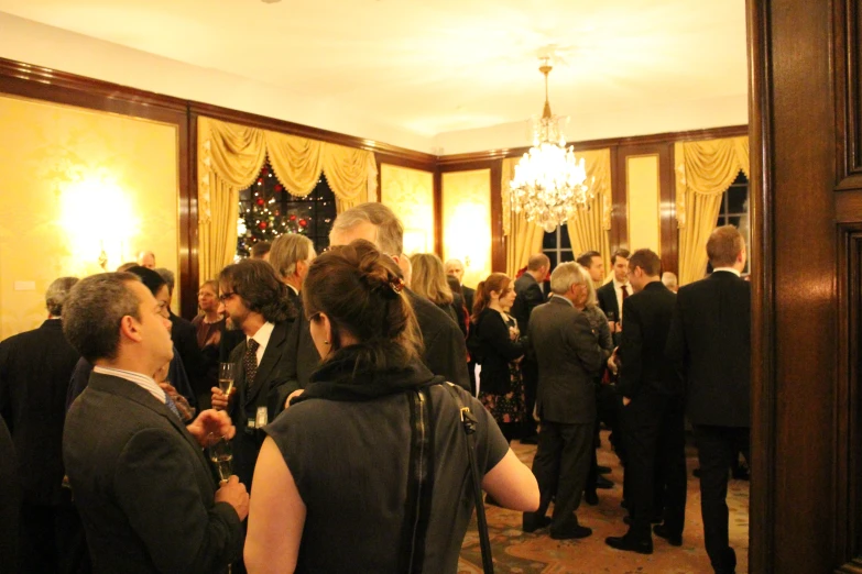 a crowd of people standing in a hall together