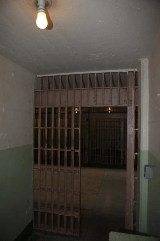 a prison cell with bars on the door