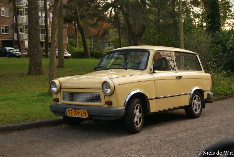 a small yellow car parked in the grass