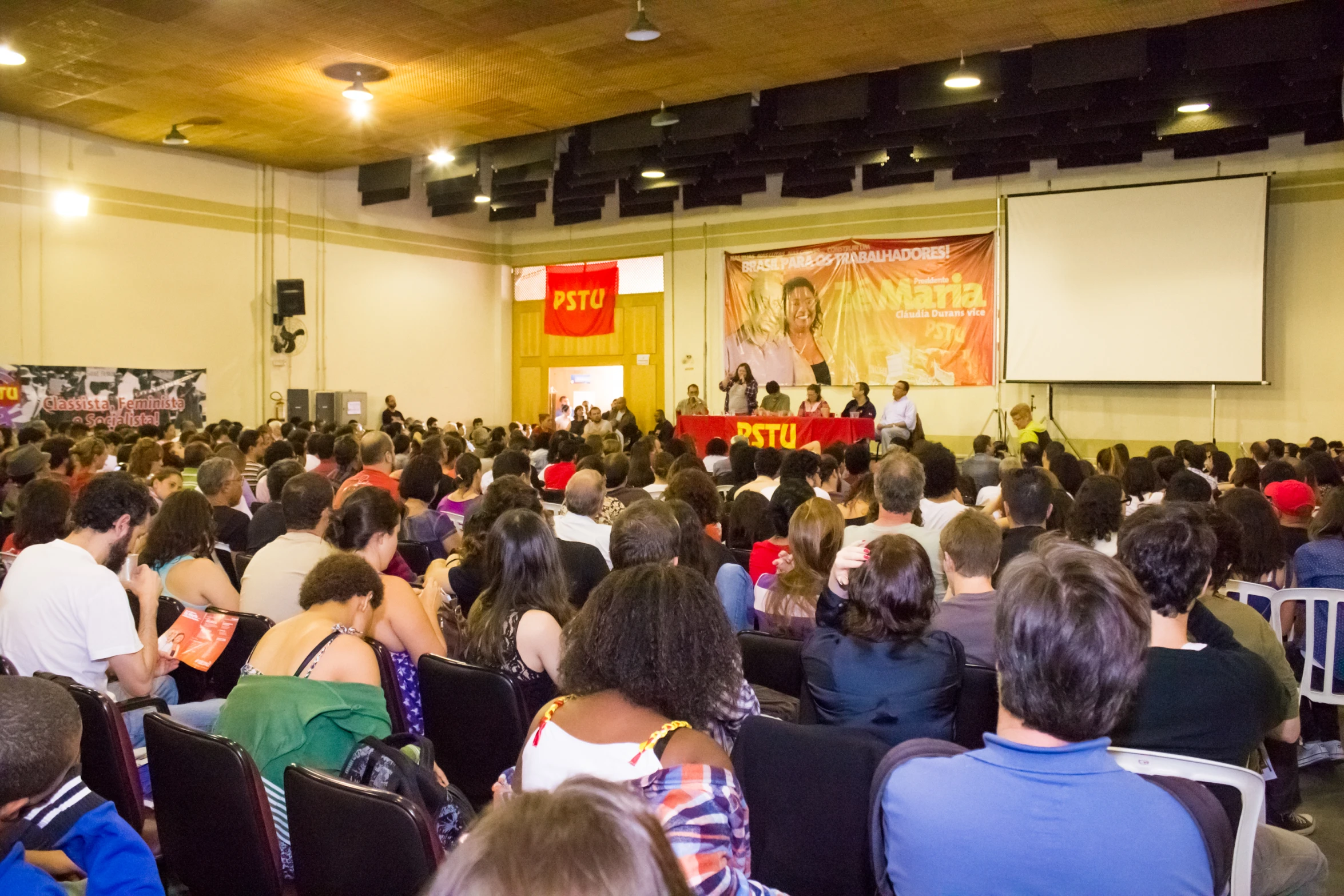 an audience of people in a hall at a business conference