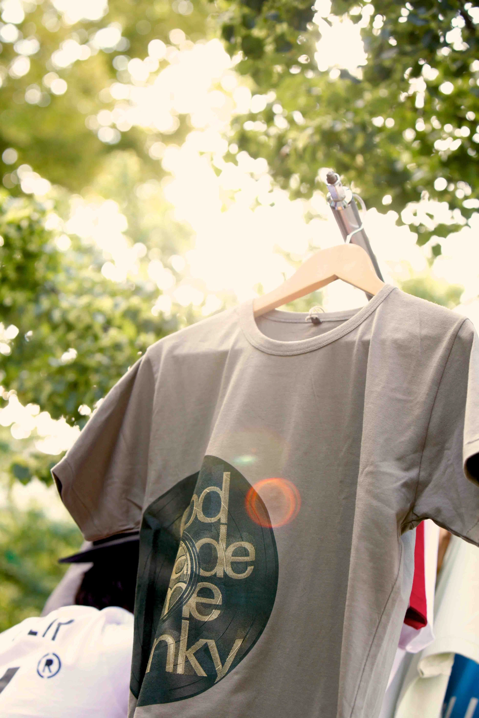 t - shirt hanging on a clothesline with trees in the background