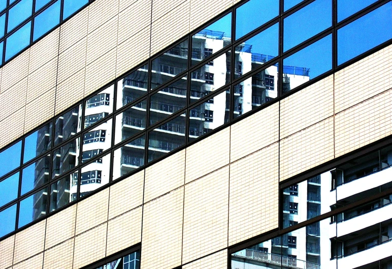 building reflection on glass windows next to it