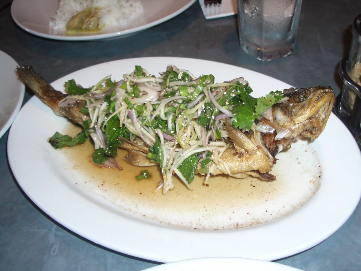 a plate of food with greens and rice