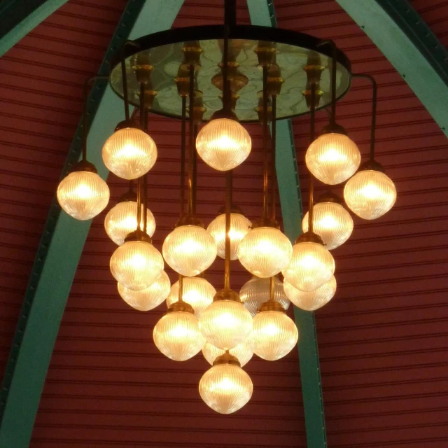 the light is hanging from a chandelier in the ceiling