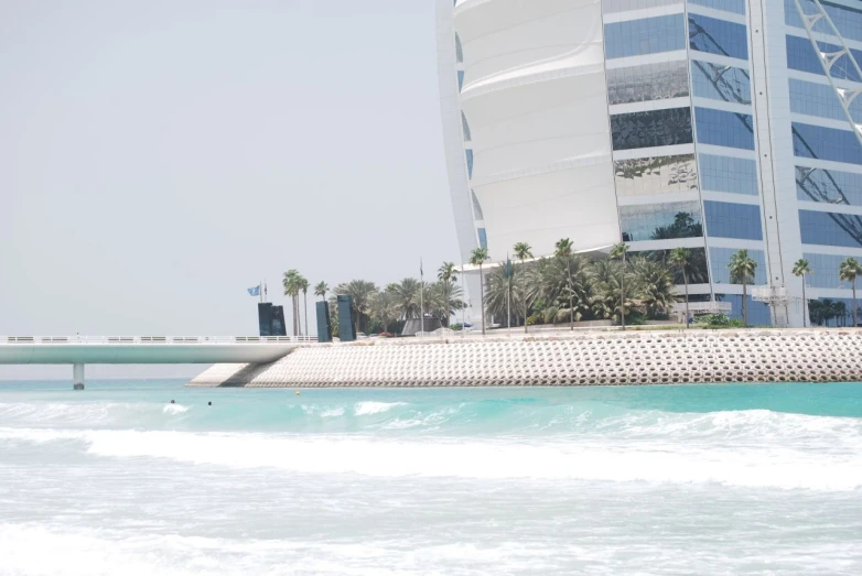 a large building with a boat sailing by