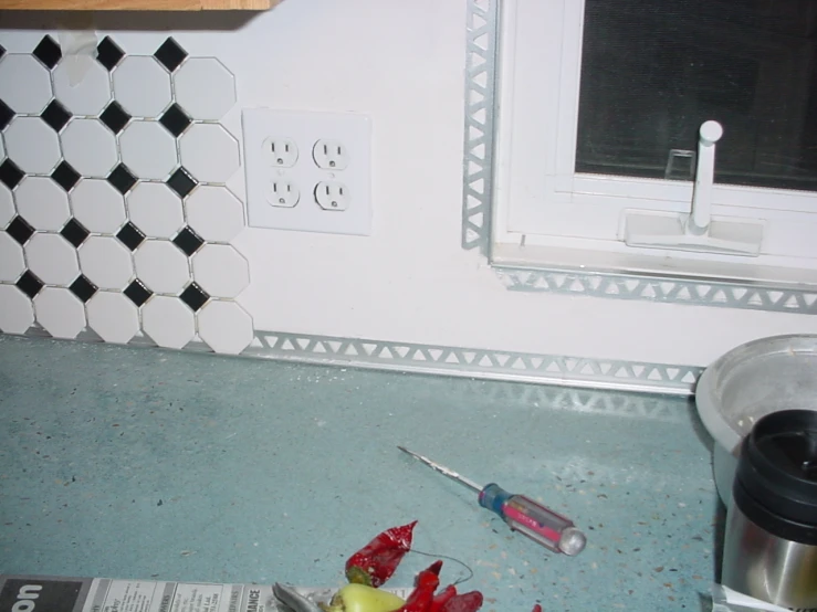 a bathroom with two knives and a broken flower