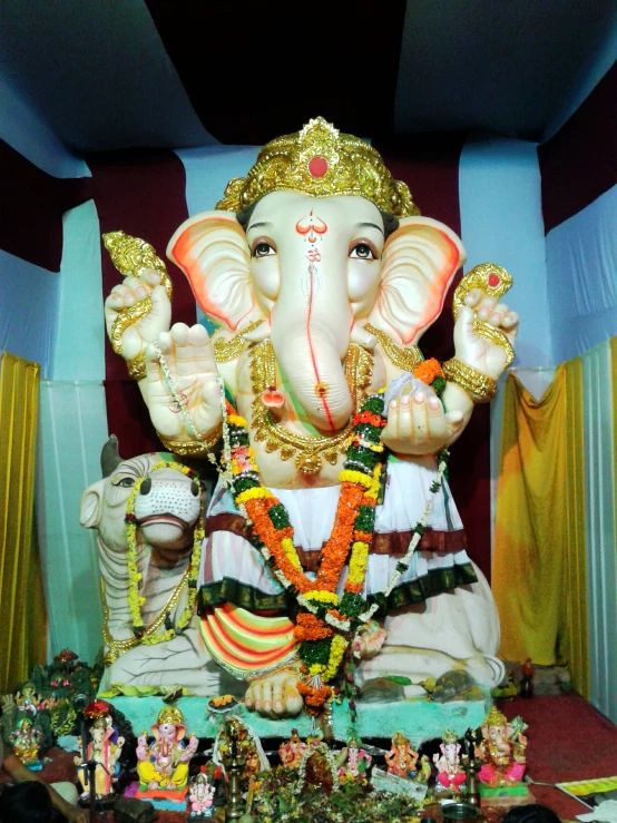 a idol depicting an elephant is displayed in a corner