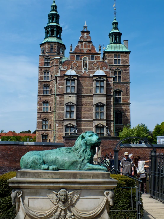 a lion sculpture in front of the castle