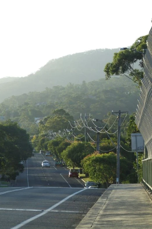 a street with a bunch of cars driving down it