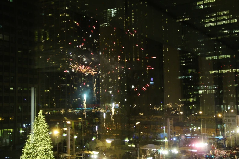 fireworks are lit up in the sky above a city