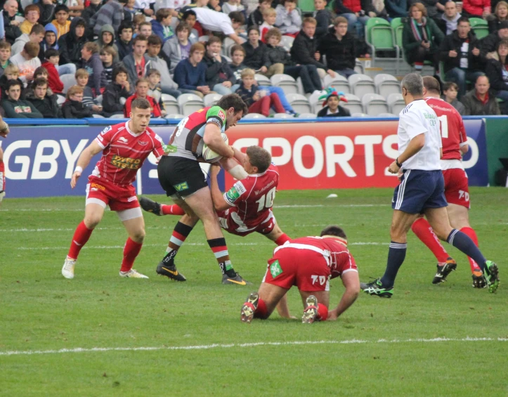 several players are on the field playing rugby