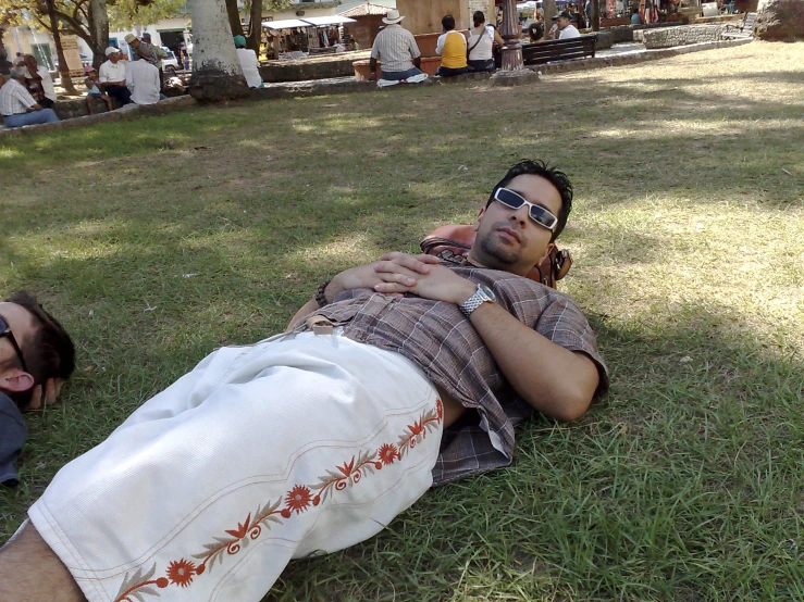 a person laying in the grass next to another persons body