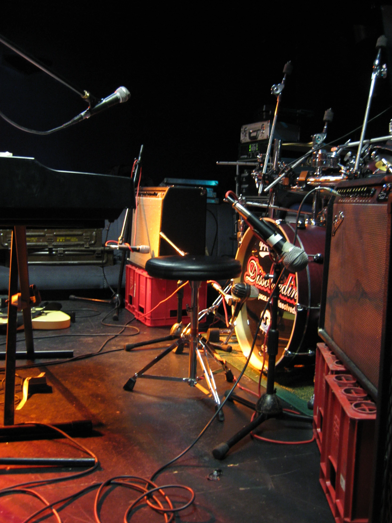 a set of drums, pedals and stands sit on a floor