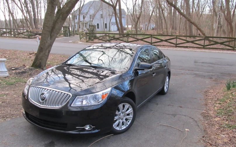 a black car is parked in a driveway