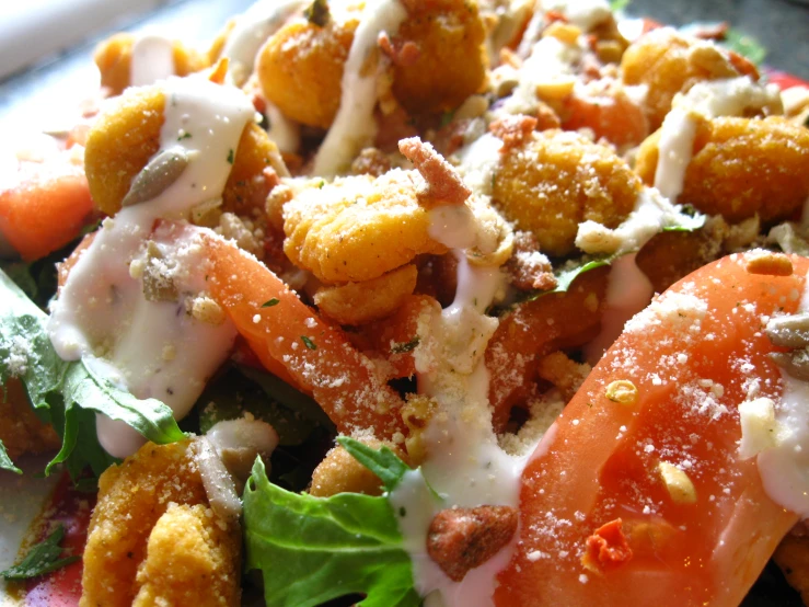 a salad with dressing and vegetables, on a plate