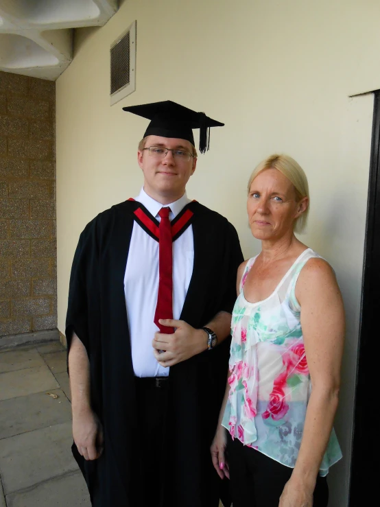 a man with a red tie standing beside a woman