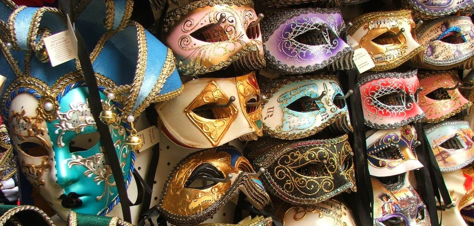 some masks are hanging up on a wall