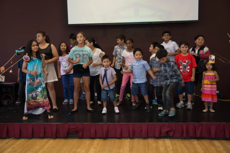 children and an adult with the words'stop bullying'in front of a large group of people