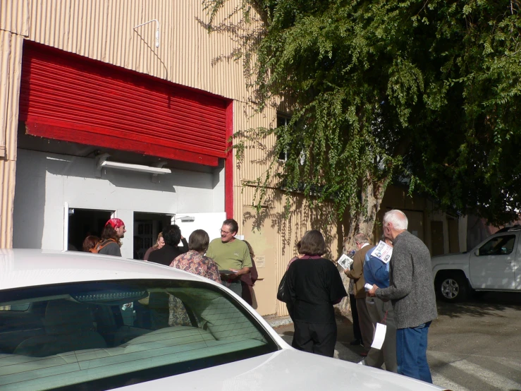 people are standing near a building looking at soing