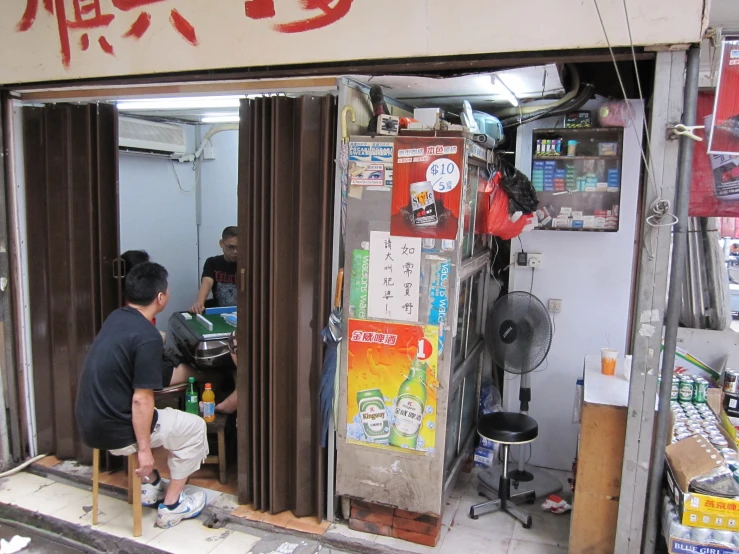 a man leaning on a closed store door