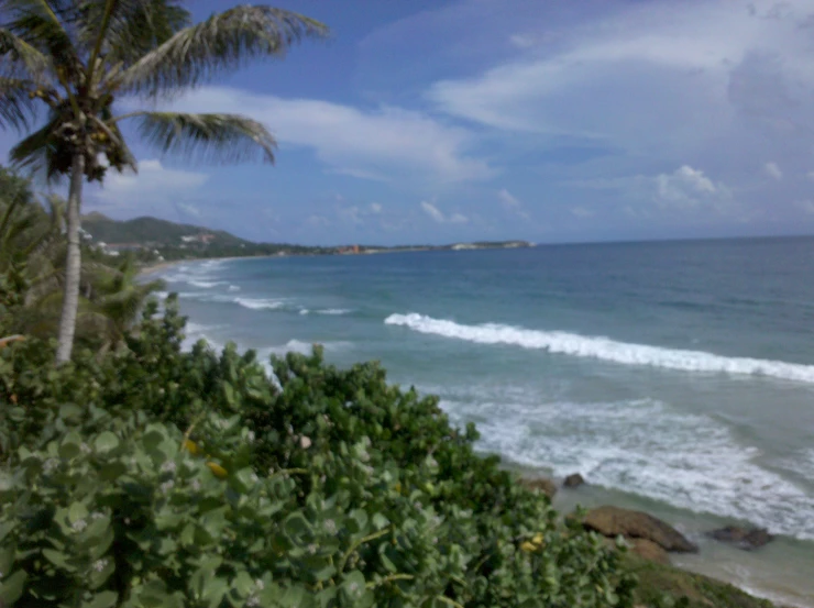 an ocean wave with small waves on the beach