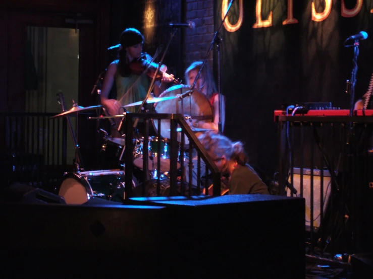 two men are on a stage with musical instruments