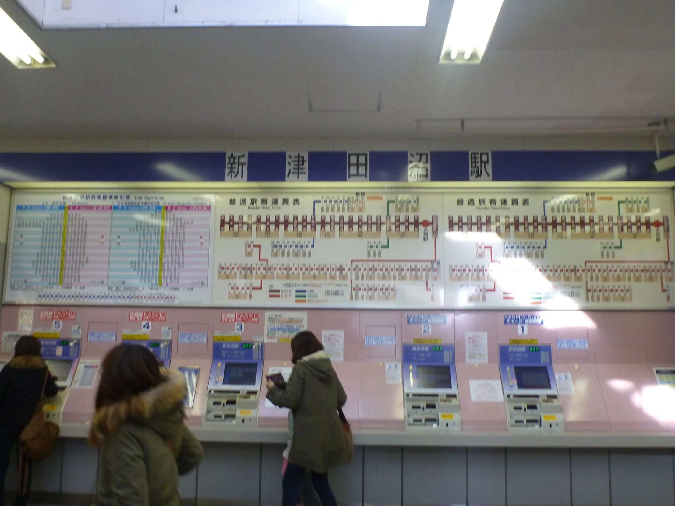 people standing in front of a wall with several different electronic devices