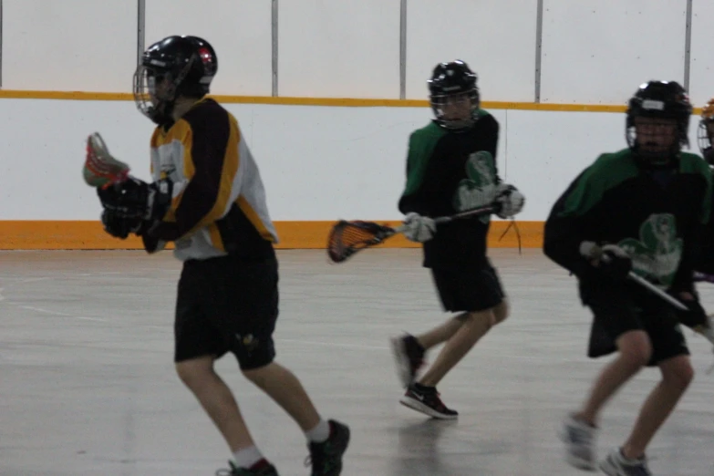 a group of people on a court playing lacrosse