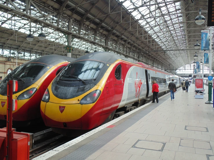 two red and white trains on some tracks