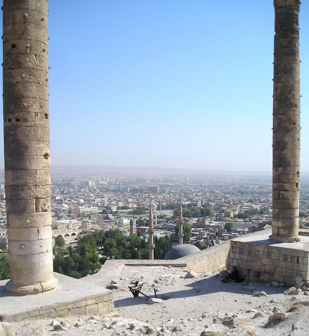 an image of two large stone pillars overlooking the city